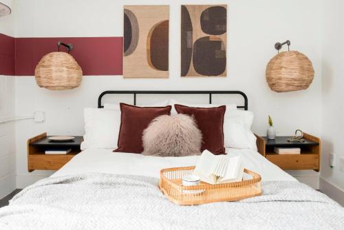 a bedroom with a bed with a basket on it at ~The Abigail~ Rooftop / Skyline / Cozy in Atlanta