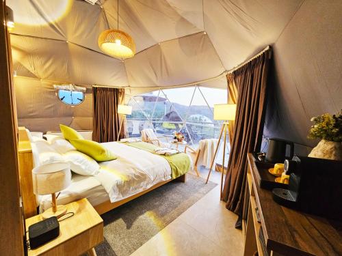 a bedroom with a bed in a tent at EcoHouse Glamping by ART HOTEL in Bishkek