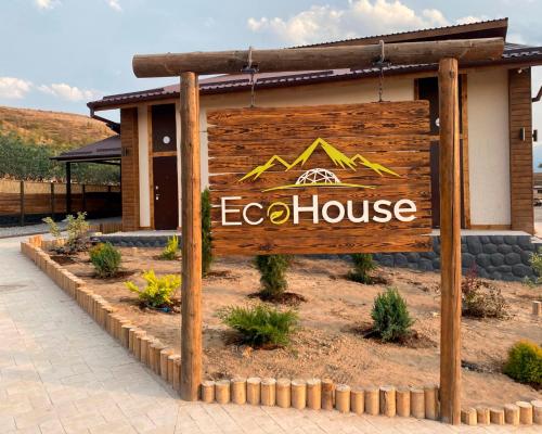a sign for an eco house in front of a building at EcoHouse Glamping by ART HOTEL in Bishkek