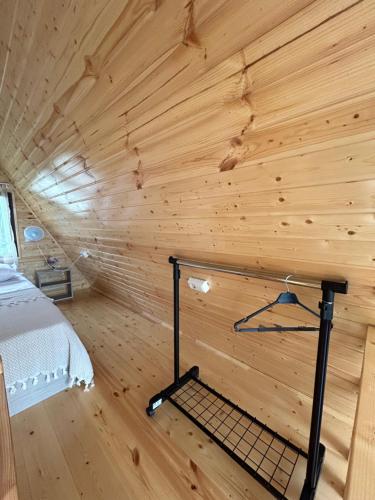 a room with a bed in a wooden wall at Cozy Home Buknari in Buknari