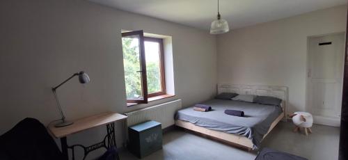 a bedroom with a bed and a window at Nature lovers house izbeigts in Stacija Bērstele