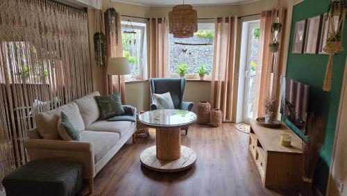 a living room with a couch and a table at FeWo Naturtraum in Kastellaun