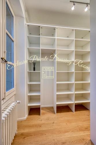 a walk in closet with white shelves at Bedroom 3 - Spacious and Bright - COLIVING in Ferney-Voltaire