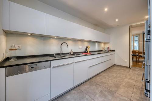 a kitchen with white cabinets and a sink at Bedroom 3 - Spacious and Bright - COLIVING in Ferney-Voltaire