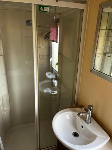 a bathroom with a sink and a shower at 33 millennium gardens in Whitley Bay