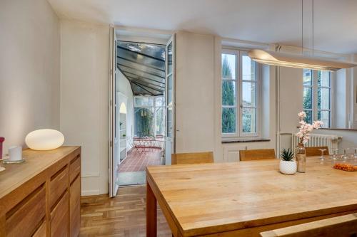 a kitchen with a wooden table and a dining room at Bedroom 3 - Spacious and Bright - COLIVING in Ferney-Voltaire