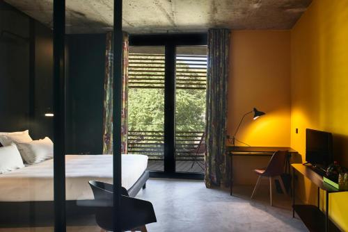 Кровать или кровати в номере Hotel La Zoologie & Spa Bordeaux