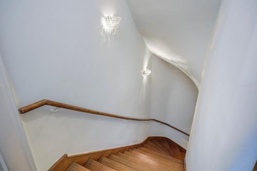 a stairway with a white wall and a stair railing at Bedroom 3 - Spacious and Bright - COLIVING in Ferney-Voltaire