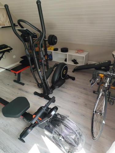 a gym with two bikes parked in a room at Chez Lily et Fred in Châlons-en-Champagne