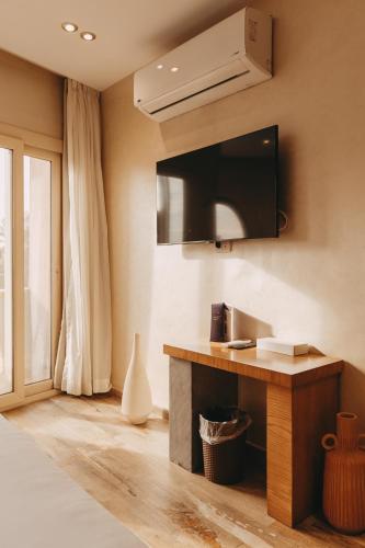 a living room with a tv on the wall at Almas Pyramids Hotel in Cairo