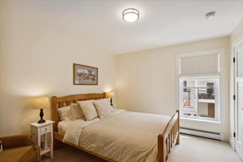 a bedroom with a bed and a window at Base Camp at Village Walk E in Stowe