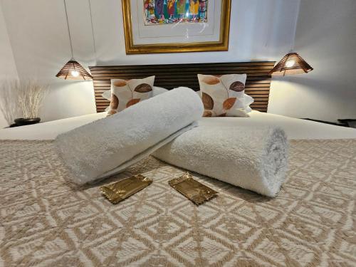 a bedroom with a white bed with a pillow on it at Leopard Corner Lodge in St Lucia