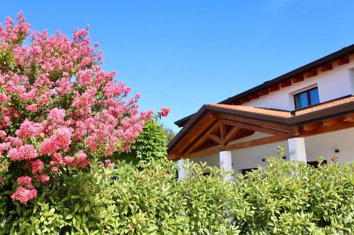 a pink flowering tree next to a building at Tenuta Tommasi - Relais Bacco in Caorle