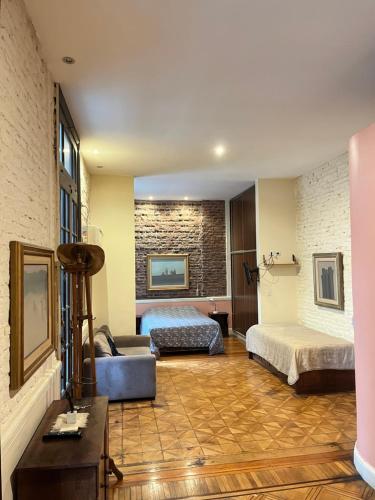 a hotel room with two beds and a couch at LOFT ALMAGRO in Buenos Aires