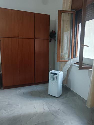 a room with a heater sitting on a tile floor at Camera Valeria in Ossi