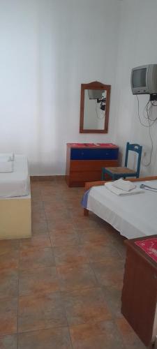 a room with two beds and a mirror on the wall at Γοργονα in Milína