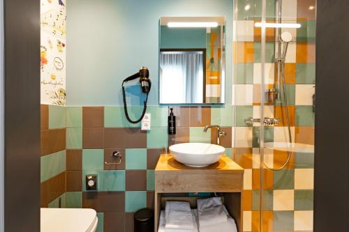 a bathroom with a sink and a mirror at Holiday Inn - the niu, Pax Berlin Airport by IHG in Berlin