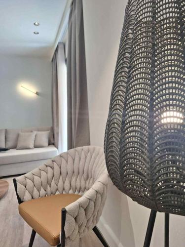 a chair in a living room with a couch at Aeolis Hotel in Samos
