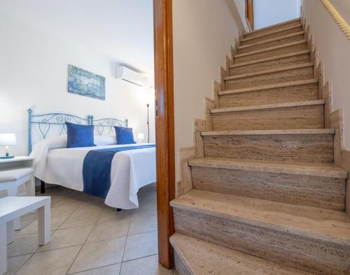 a bedroom with a bed and stairs leading to a bedroom at Casa Ninnì Positano in Positano