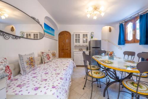 a room with a bed and a table and a kitchen at Casa Ninnì Positano in Positano