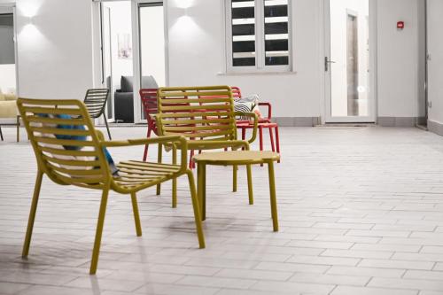 a group of chairs and a table in a room at Dimora Domitia - Apartments in Mondragone