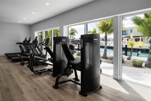 a row of treadmills and exercise bikes in a gym at Blue Haven Resort- All Inclusive in Grace Bay