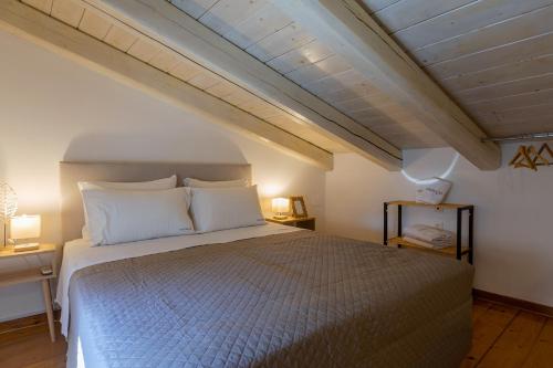 a bedroom with a large bed with white pillows at Luna di porto in Corfu Town