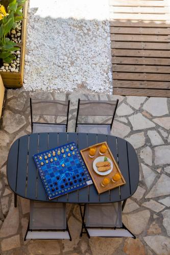 a table and chairs with a chess board on it at Luna di porto in Corfu Town