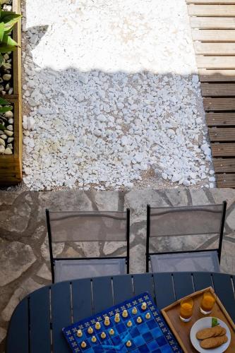 a blue table and chairs with a chessboard on a patio at Luna di porto in Corfu Town