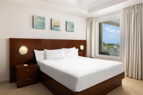 a bedroom with a large bed and a window at Blue Haven Resort- All Inclusive in Grace Bay