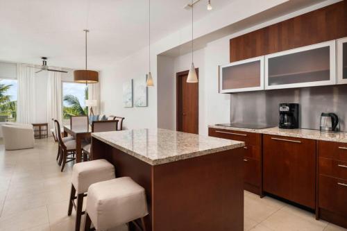 a kitchen with a counter and a dining room at Blue Haven Resort- All Inclusive in Grace Bay