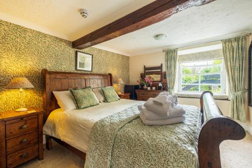 a bedroom with a bed and a window at The Old Mill House in Padstow