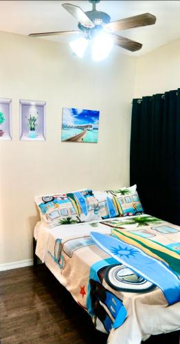 a bedroom with two beds and a ceiling fan at Santa Cosy Villa suite-B Fast Wi-Fi, Netflix Included Split system Air-con & Hot Shower Close to Enchanted Kingdom in Santa Rosa