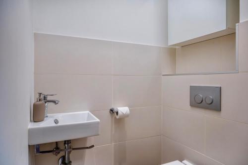 a white bathroom with a sink and a toilet at Bedroom 6 - Unique Experience - COLIVING in Ferney-Voltaire