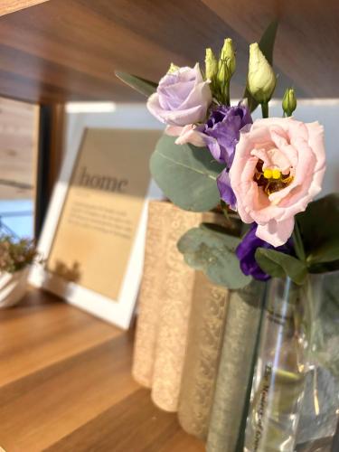 a vase with flowers in it on a table at Pineview House in Kolašin