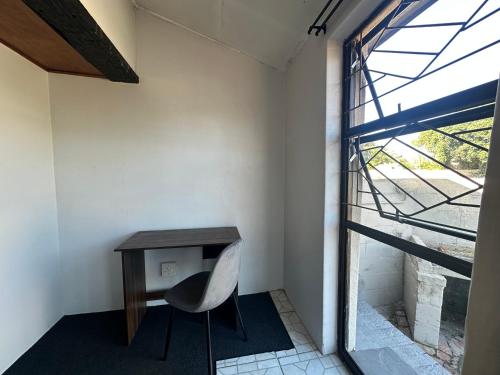 a room with a desk and a chair next to a window at Suite Dreams Spacious Apartment in Panorama