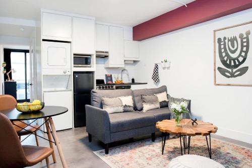 a living room with a couch and a kitchen at *NEW* The Scarlet - Downtown | Balcony | Skyline in Atlanta
