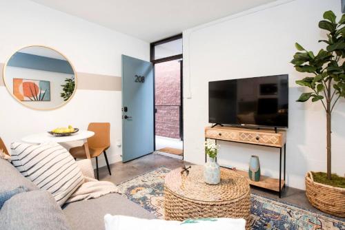 a living room with a couch and a tv at <NEW> The Jewel - Balcony | Walkable | Ponce City in Atlanta