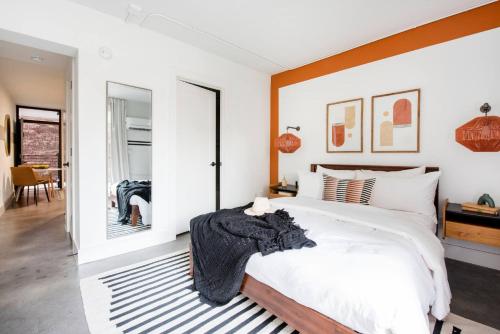 a bedroom with a large bed with a wooden headboard at <NEW> The Jewel - Balcony | Walkable | Ponce City in Atlanta