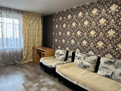 a hotel room with two beds and a window at Назарбаева 204 in Pavlodar