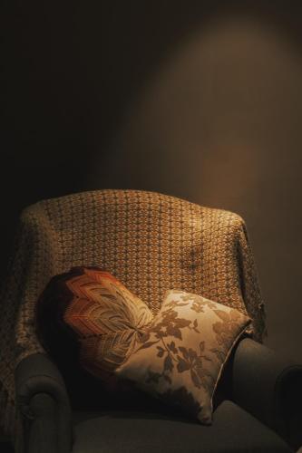 a pillow sitting on the back of a chair at 眷村1954 Guest House in Taipei