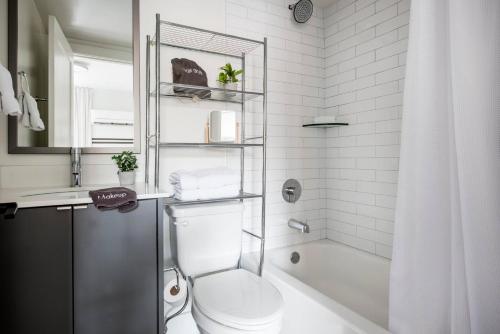 a white bathroom with a toilet and a shower at <NEW> The Jewel - Balcony | Walkable | Ponce City in Atlanta
