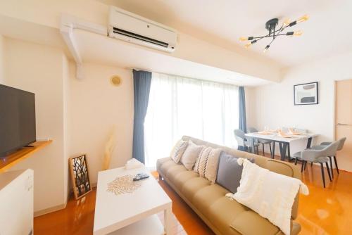 a living room with a couch and a table at right next to Sapporo and Susukino!Maximum 6 people,4 minutes from the station, quiet area A177 in Sapporo