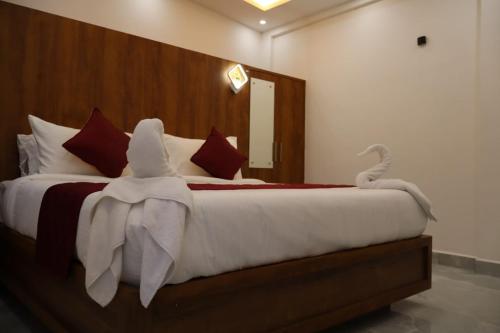 a bedroom with a large bed with towels on it at Rhythm Stays in Munnar