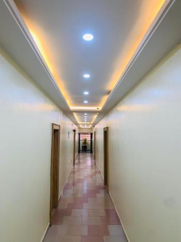 a hallway in an office building with a ceiling at Eagle Nest Apartment and Hotel in Benin City