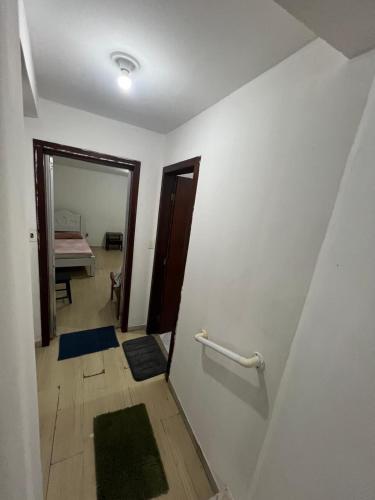 a room with a hallway with a mirror and a door at Casa Camburi 1 in Vitória