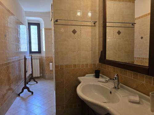 a bathroom with a sink and a mirror at L'Antico Convento casa storica in Castiglione della Pescaia