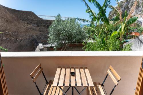a table and chairs on a balcony with a view at Casa Ninnì Positano in Positano