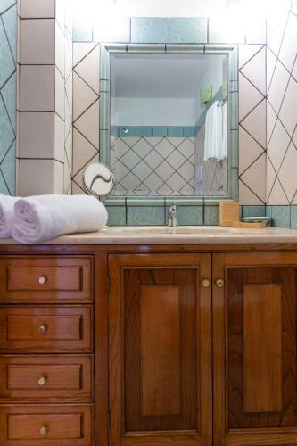 a bathroom with a sink and a large mirror at Casa Ninnì Positano in Positano