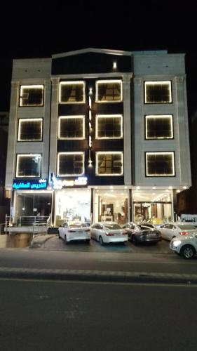 a building with cars parked in front of it at فرس أبها حي الموظفين شارع البديع in Abha